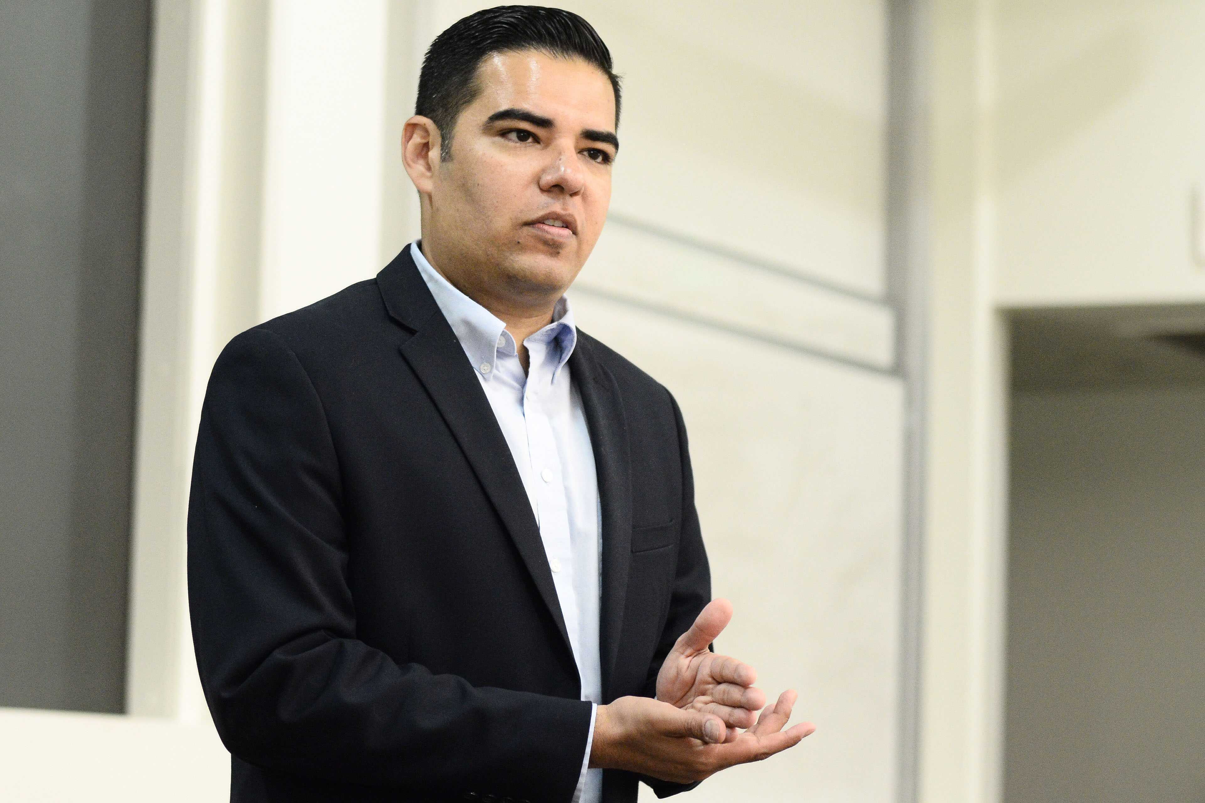 Picture contains Mayor Robert Garcia standing in front of a white building