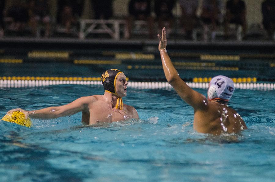 Pacific attacker Eli Lule tries to reach for the ball, held by Long Beach State junior attacker Austin Stewart.
