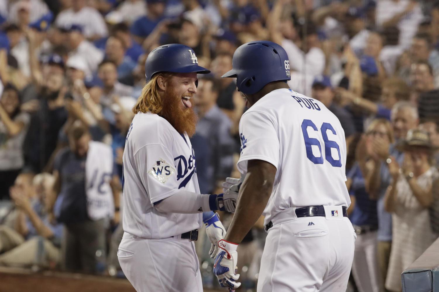 The Los Angeles Dodgers Justin Turner celebrates with Yasiel Puig after he hit a two-run homerun in Tuesday’s World Series opener at Dodger Stadium. Los Angeles defeated the Houston Astros, 3-1.