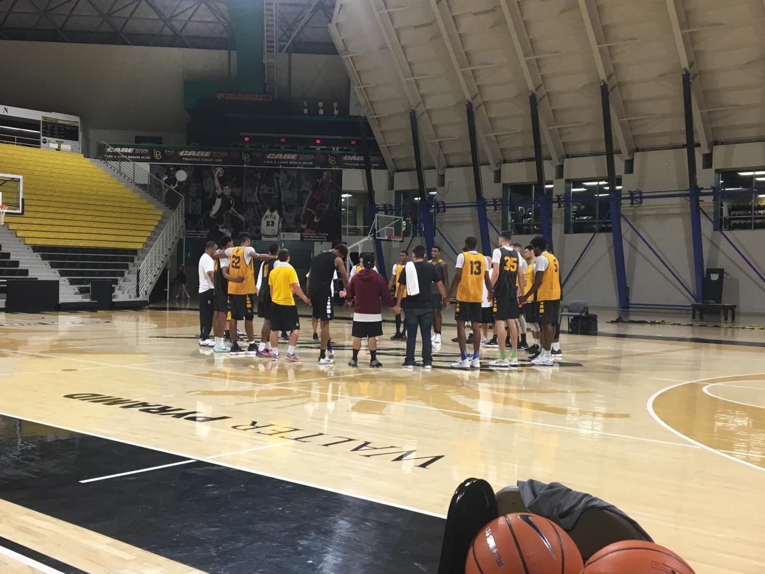 The Long Beach State men’s basketball team huddles together after practice Wednesday morning.