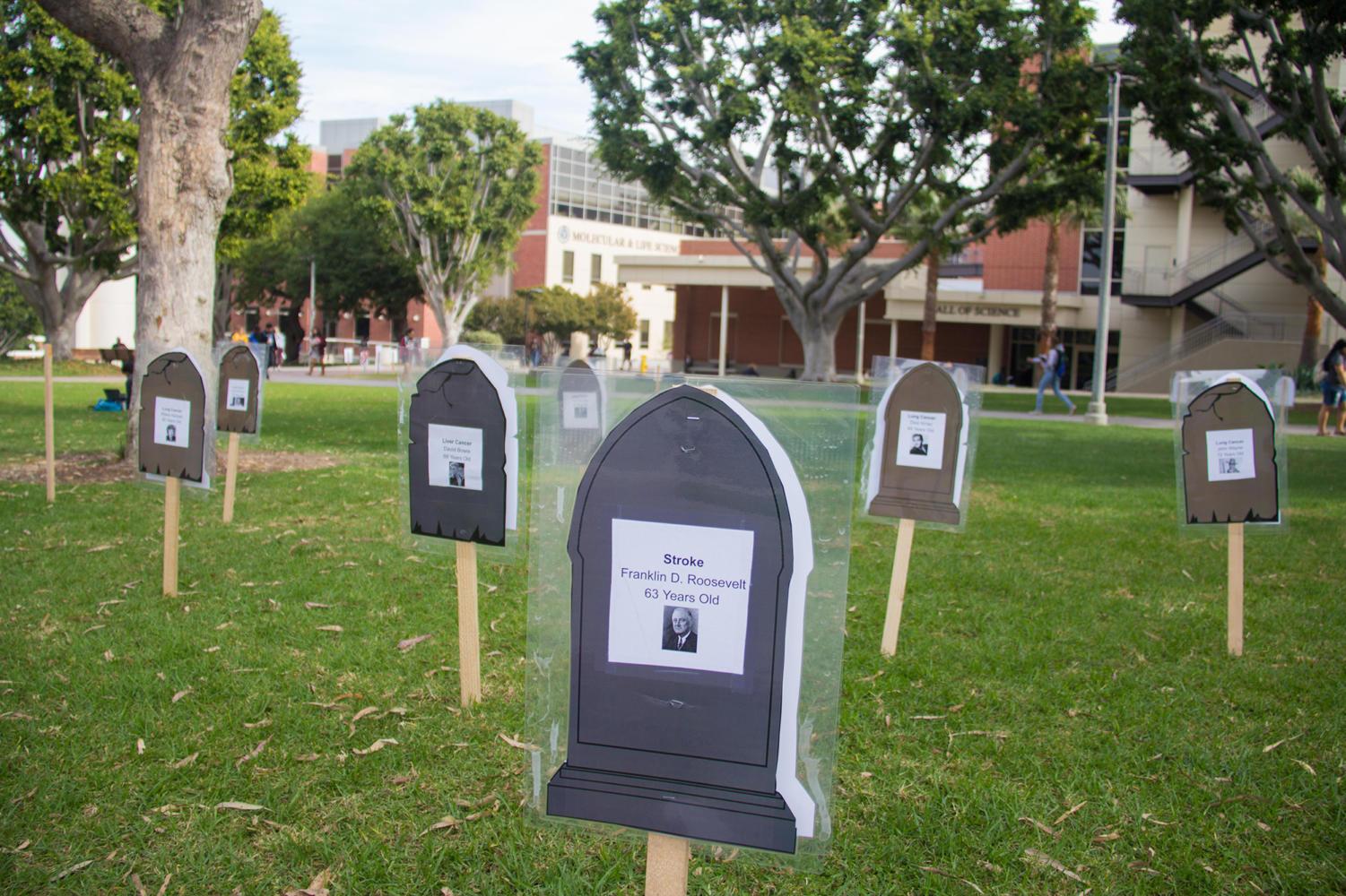Celebrities' tombstones with smoking-related deaths were displayed on the lawn in front of the bookstore on Wednesday 11/15.