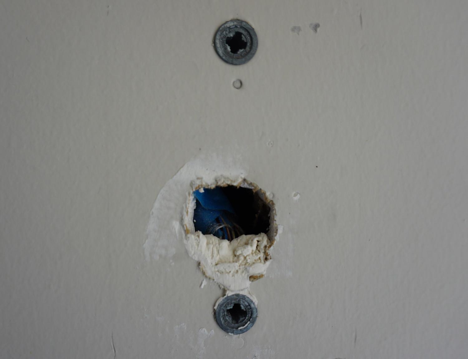 A wall in the Fine-Arts-2 building contains an unpatched hole, exposing an electrical wire 12/6.