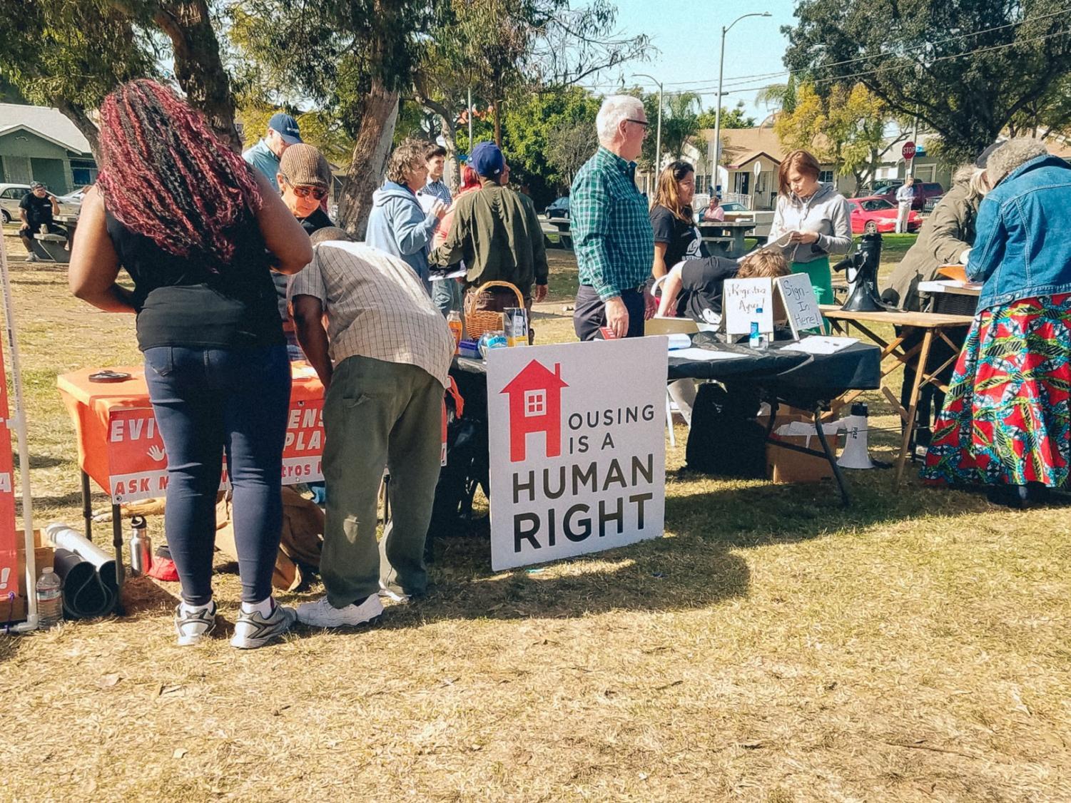 Long Beach residents line up to sign a petition by #RentControlNow at MacArthur Park on Sunday. The petition is aimed at getting rent control to be added to the election ballots this upcoming November.