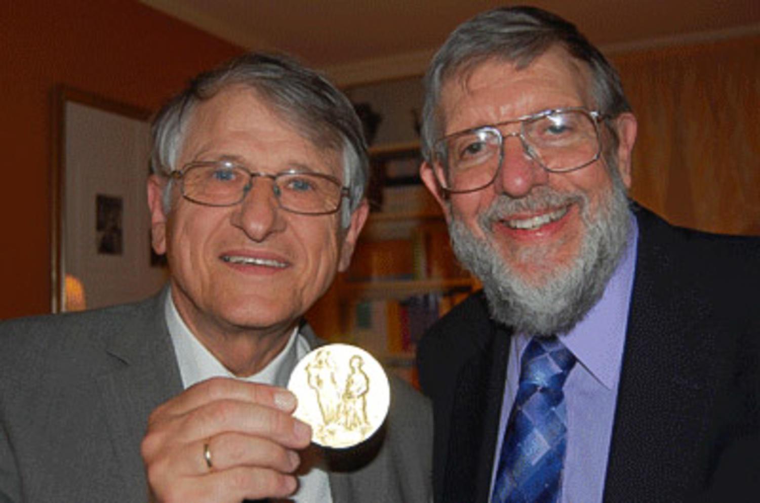 Klaus von Klitzing (left) and William Phillips sport von Klitzing’s Nobel award medal that he received in 1985. Phillips will be speaking at the 39th annual Nobel Laureate Lecture on April 11 in the University Student Union Ballrooms.