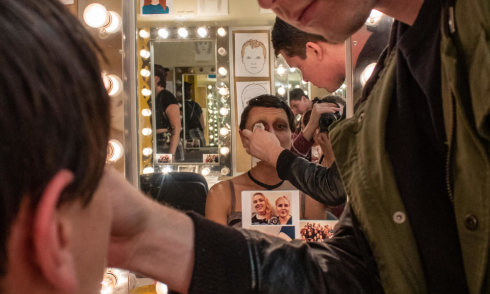 Photo Contains: a male makeup artist does the makeup of a theater actor for "Cabaret."