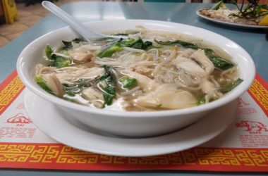 The phở with chicken slices, number 21 on the menu at Phở Long Beach, is served with a side of bean sprouts and mint leaves.