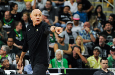 A coach pointing to the court.