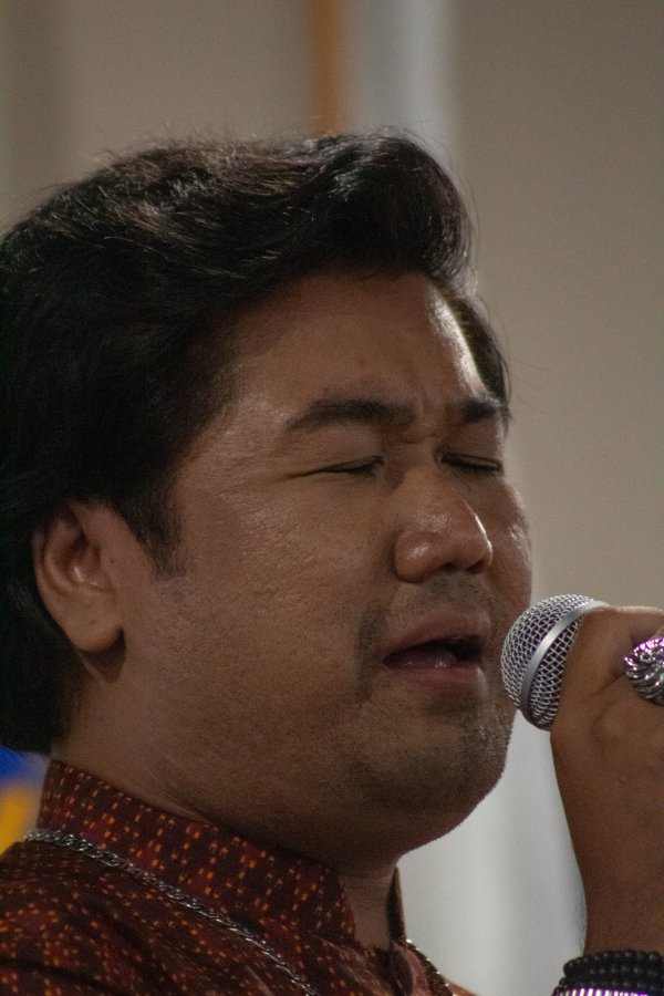 Man sings passionately.