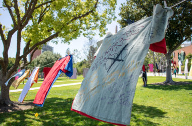 T-shirts detailing messages from many women about their experiences with sexual assault hang on a clothesline.