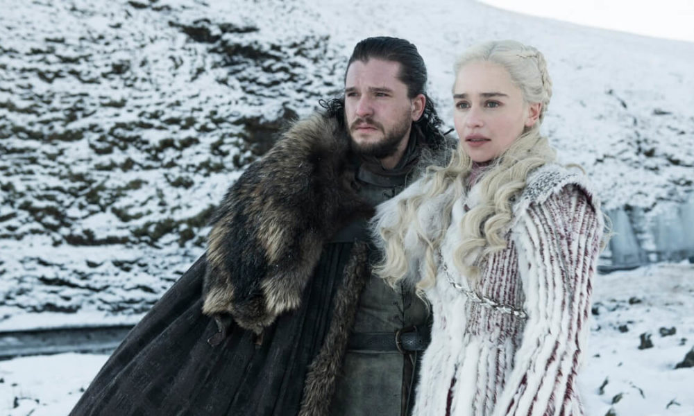 Jon Snow and Daenerys Targaryen look off the side in surprise.