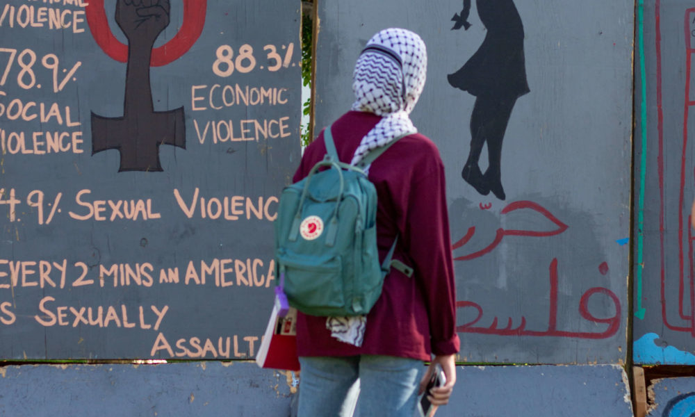A student walks past the Apartheid Wall
