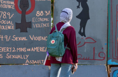 A student walks past the Apartheid Wall