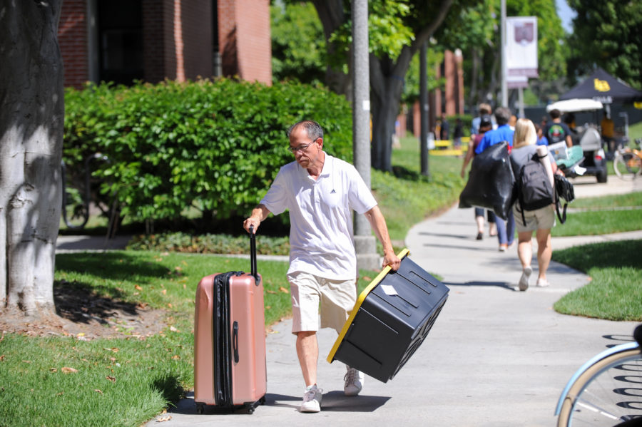 guy with luggage at Parkside Dorm