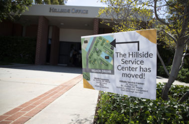 A lawn sign displays a message that says "Hillside Service Center has moved," along with a mpa to its location.