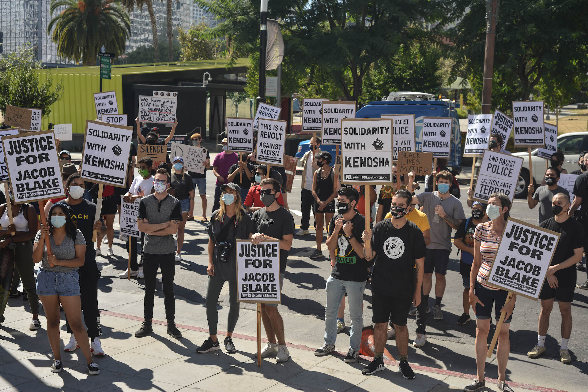 A group of protestors gather in front of the L.A. City Hall