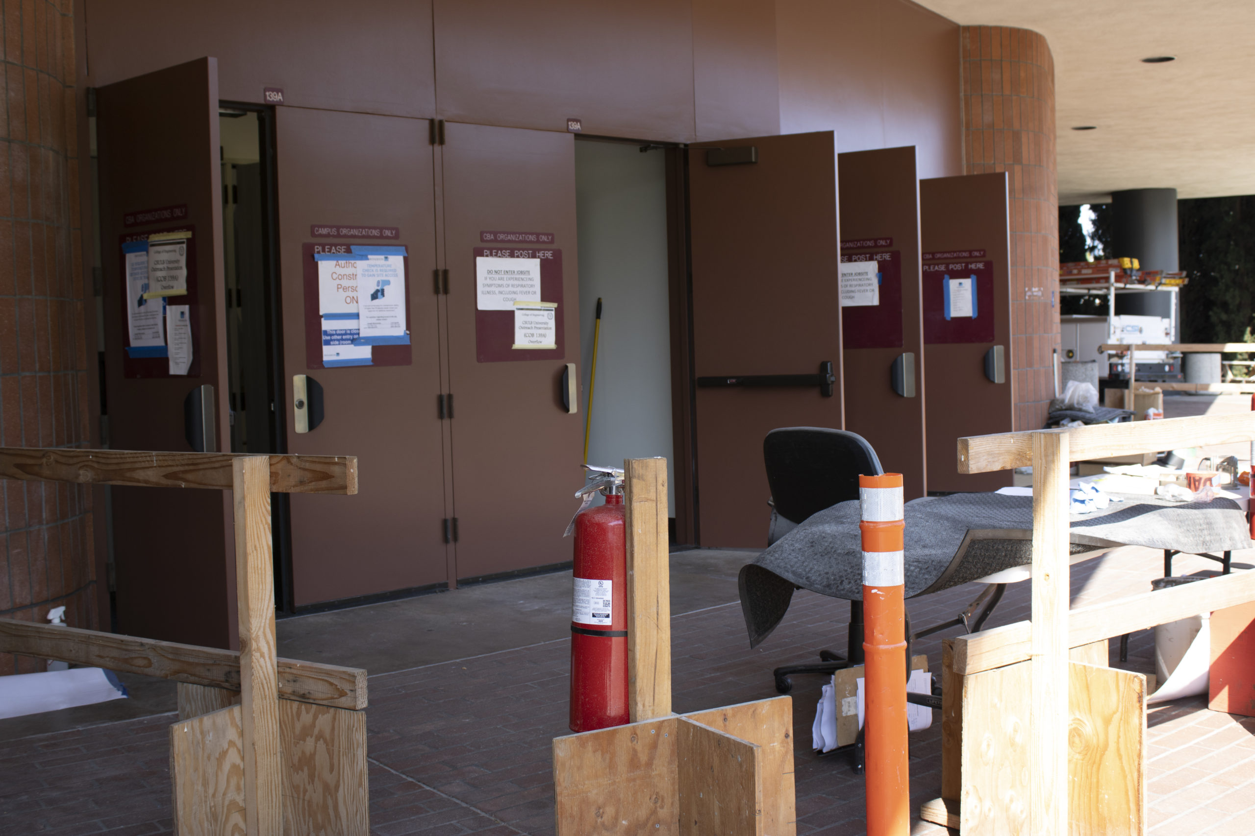 Construction is being conducted on a classroom in the College of Business. Chairs and construction materials are outside the room