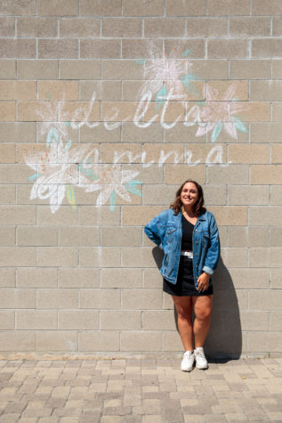 A photo of student Kendel Karal standing in front of a wall