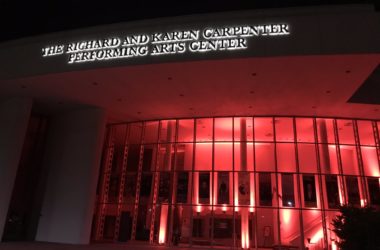 A photo of the Carpenter Center illuminated in red