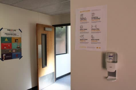 A warning sign on the wall inside the Parkside Dormitory describes rules for coronavirus adherence 