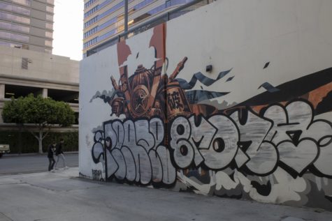 Mural artist Dragon76 participated in the 2015 POW WOW Long Beach event. Since then the mural has been covered by local graffiti artist signatures.