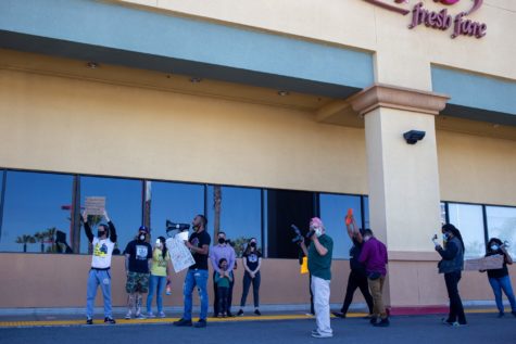 About a dozen are gathered Sunday afternoon in front of the Ralphs location at Marina Pacifica Mall in Long Beach to boycott Kroger Co. for not distributing "Hero Pay" to its workers. Julia Terbeche/ Daily Forty-Niner