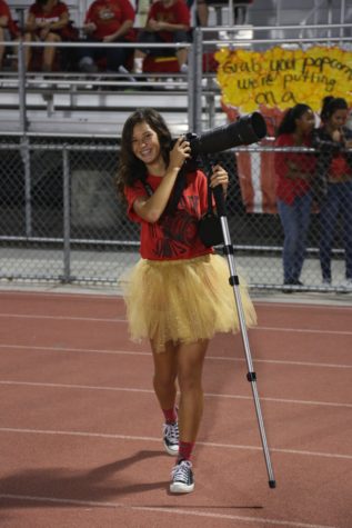 Ashley Ramos photographing a football game for yearbook in her sophomore year of high school.