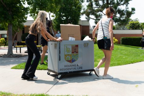 A student and family member pushing a cart to their dorm on move-in day at CSULB on Thursday, Aug. 18.