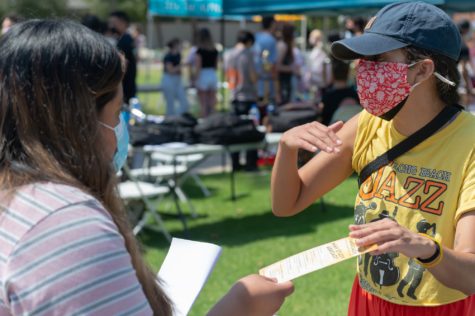 Jessica Barrios Frankos, 27, international studies major, hands out bookmarks to students interested in joining the study abroad program during the Week of Welcome at CSULB on Monday, Aug, 30.