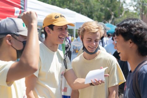 During Week of Welcome, fraternities and sororities are stationed on the same aisle, which draws the most crowds, including Phi Kappa Tau, who talk to various students to join on Monday, Aug. 30.