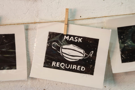 "Mask required" prints Cody Lusby created for local businesses hang in his studio space during the Long Beach Open Studio Tour in Long Beach, Calif. on Oct. 3.