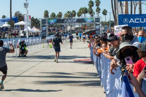 Crowds comprised of family and friends cheer runners at East Ocean Boulevard during the Long Beach Marathon on Sunday, Oct. 10.