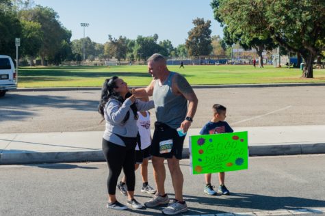 Gabriela Bombace along her two sons rejoins with John Bombace near East Atherton Street for the Long Beach Marathon on Sunday, Oct. 10.