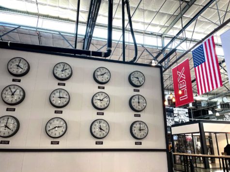 Long Beach cities clock wall inside the LBX Hangar, displaying different Long Beach's across the country.