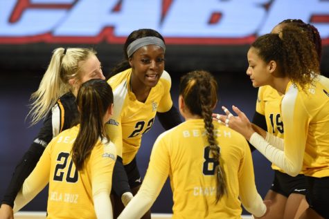 Featured: No. 22 CSULB Outside Hitter Kashuana Williams celebrating with her team after making a kill.