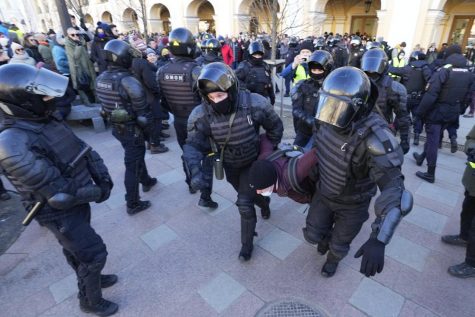 Photograph showing a demonstrator being detained and carried away by police during a protest against the Russia-Ukraine war in St. Petersburg, Russia.