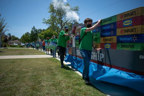 A group of climate change activists protest shipping pollution on Earth Day as the march to Target.