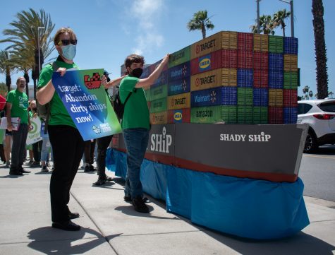 Environmental activist march with their "Shady Ship" float on Earth Day to protest shipping pollution and climate change.