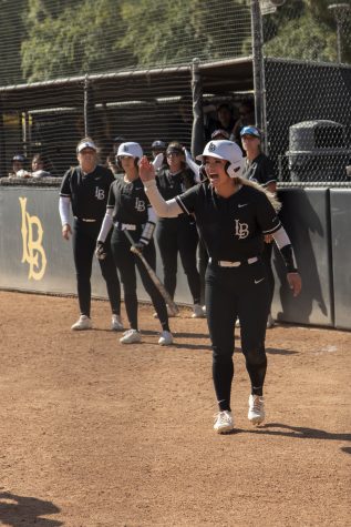 Long Beach State Softball cheering each other on just after the team scored a pair of runs.