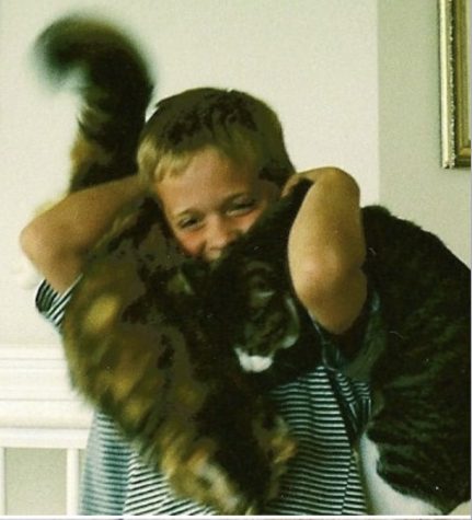Krawl as a child with two cats on his shoulder