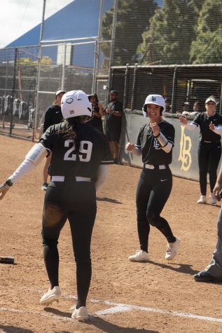 Naomi Hernandez celebrating with her teammates just after she scored a run to keep The Beach's momentum going