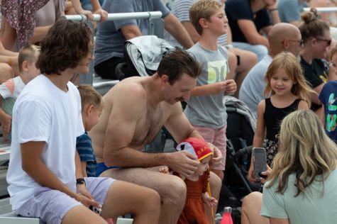 09/10/2022 - LONG BEACH, CALIF: CSULB MWPOLO Alumni, Derek Bailey, put his wet swim cap over his daughter's head during the CSULB MWPOLO vs. Alumni game.