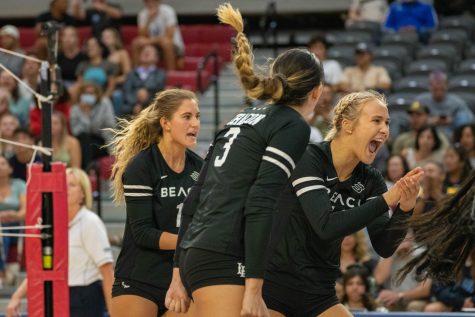 Zayna Meyer (#1), Morgan Chacon (#3), and Katie Kennedy (#18) (L-R) of the CSULB Women's volleyball team celebrate a successful kill against Loyola Marymount at Gersten Pavilion on Friday, Sept. 17, 2022.