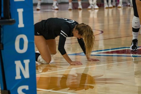 Zayna Meyer (#1) of the CSULB Women's volleyball team struggles to pick herself up after a harsh fall against Loyola Marymount at Gersten Pavilion on Friday, Sept. 17, 2022.