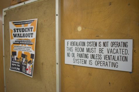Signs in the Fine Arts 4 building disclose that rooms must be ventilated, and a flyer next to it promotes a student walk-out over the lack of air conditioning.