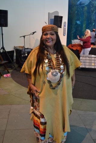 Emcee and speaker Jacque Tahuka-Nunez of the Acjachemen Nation poses in traditional indigenous clothing including shell necklace. The Acjachemen people have a long history in the local area and deep connection to the ocean.