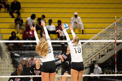 Long Beach State women's volleyball players, Callie Schwarzenbach (left) and Katie Kennedy (right), go for a block on a kill attempt during Saturday night's matchup against Loyola Marymount University at Walter Pyramid.