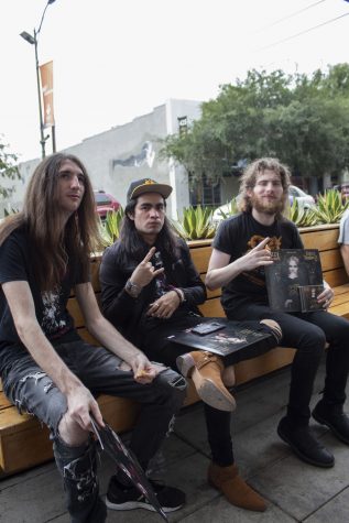 Johnny Heinz(left), Erick Garcia and Nathan Shapiro sit outside Fingerprints Music having just had their records signed by Ozzy Osbourne.