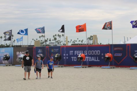 A family heads to the NFL kickoff event at Alamitos Beach.