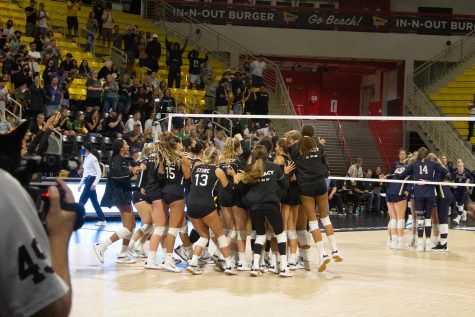 CSULB Women's volleyball team storm the floor as they celebrate their win against Notre Dame inside the Walter Pyramid on Saturday, Sept. 3, 2022.