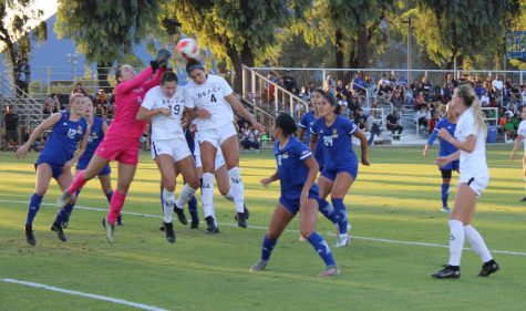 After a corner kick, UC Riverside goal keeper Cassia Souza stops the Long Beach players Sophie Jones (left) and Lena Silano (right) from conceding a goal.
